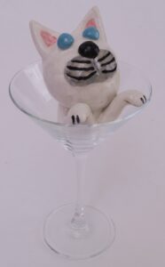 cat swimming in wine glass